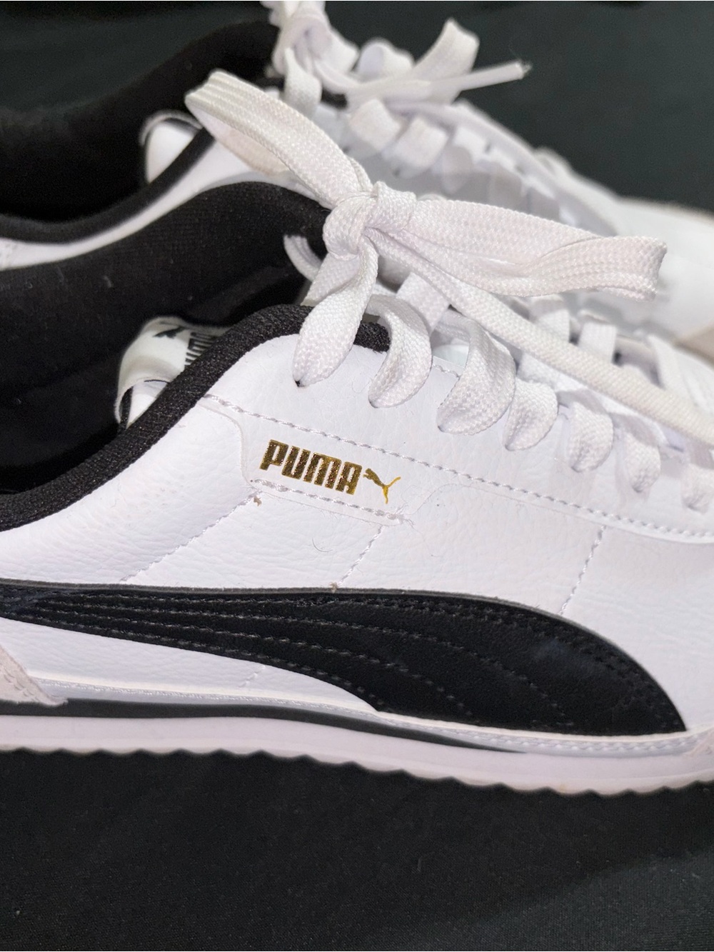 Puma White and Black Low-Top Sneaker with Gold Logo Accent